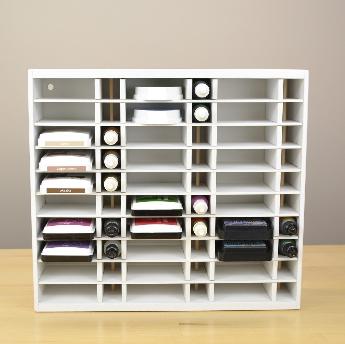 Direct view of an organizer for ink pads and refill bottles, painted white.