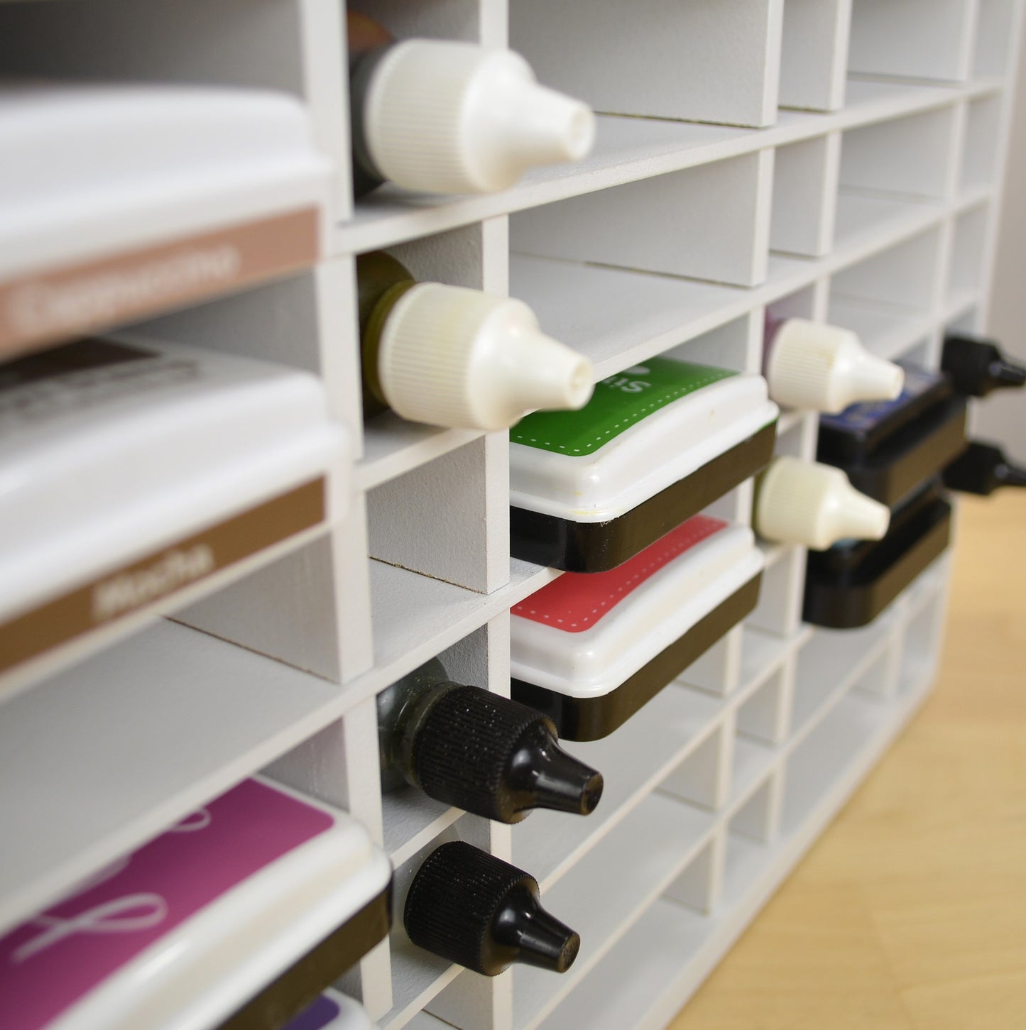 Side view of ink pads and refill bottles in a craft storage holder from OrganizeMore.