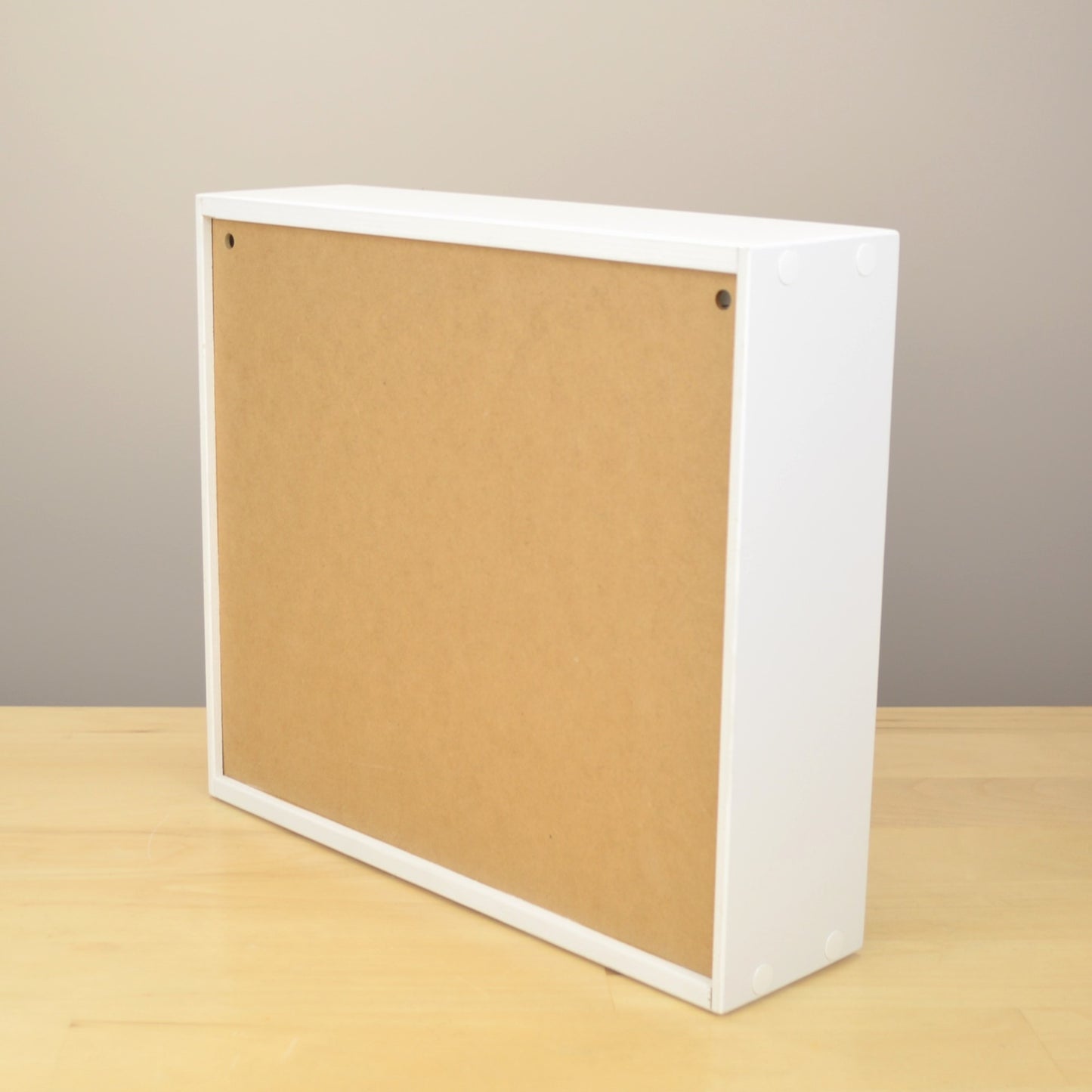 Back view of an ink pad organizer showing the holes for wall mounting.