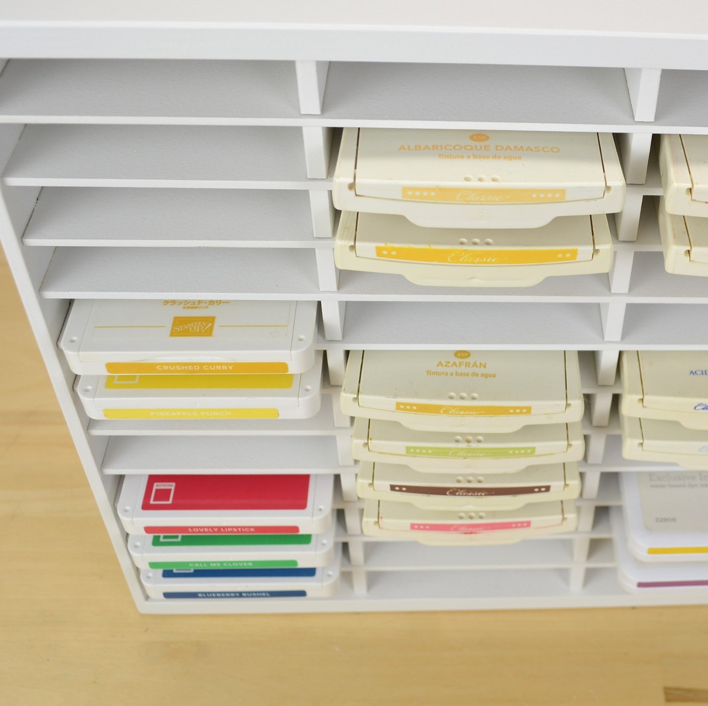 Downward view of ink pads in a storage organizer showing how far they stick out.