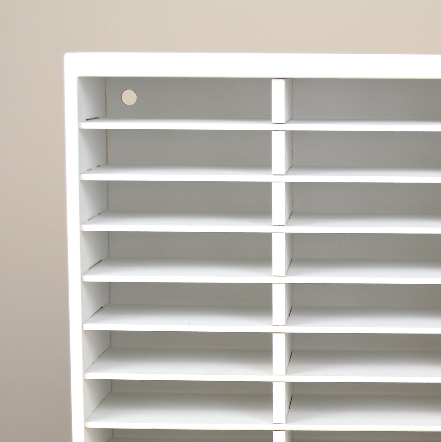 Closeup view of an ink pad holder showing the holes for wall mounting.