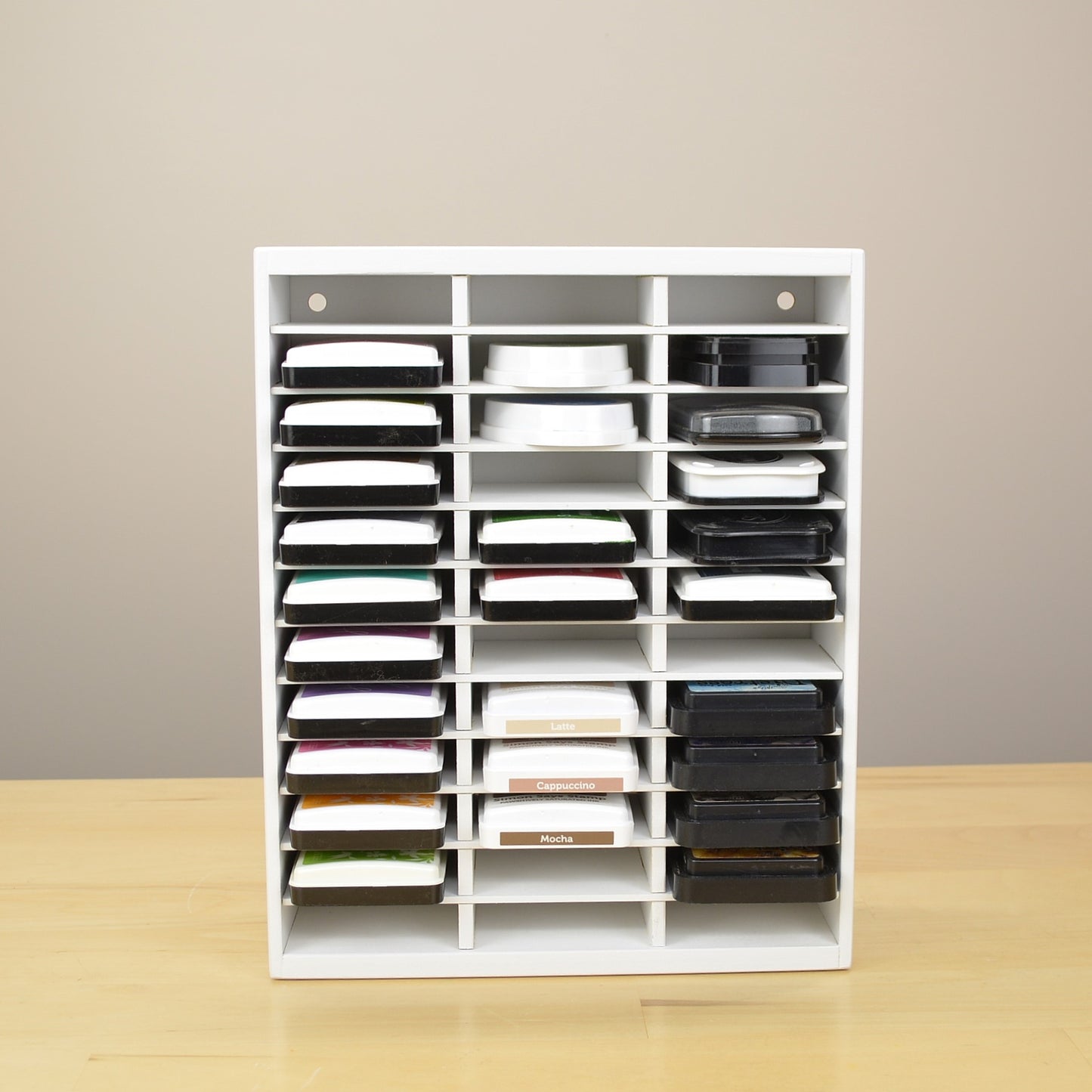 Direct view of an OrganizeMore ink pad organizer ull of inks and painted white.