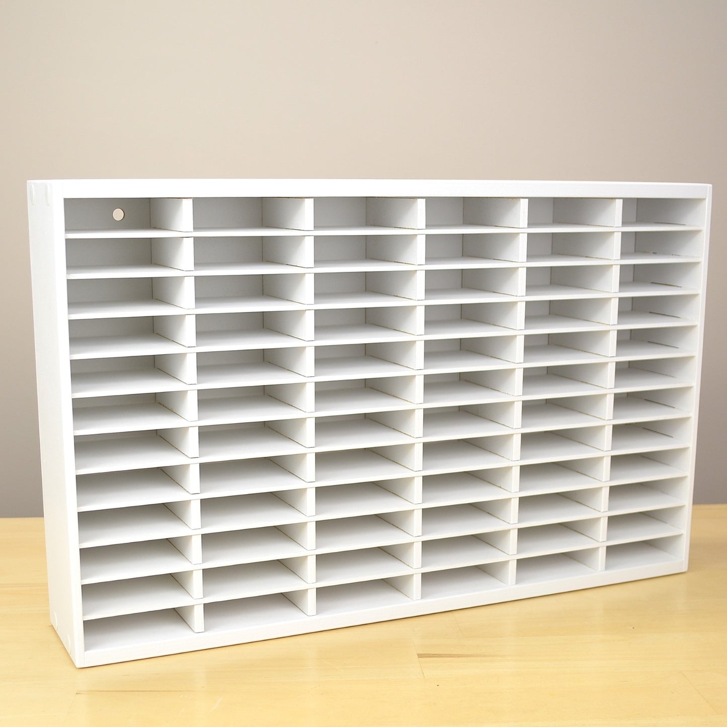 A white storage organizer made to hold 72 ink pads.