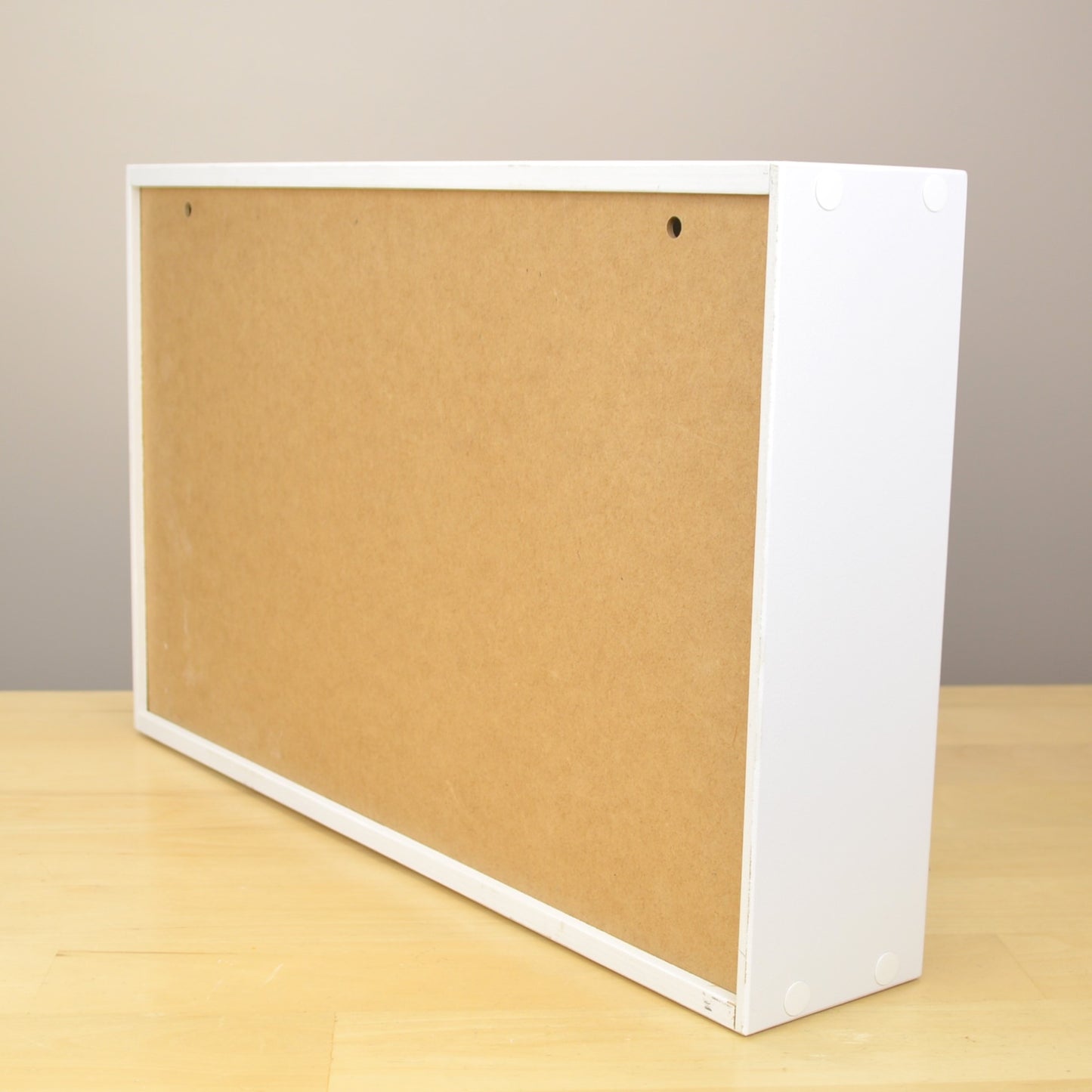 Back view on an ink pad organizer showing the holes for wall mounting.