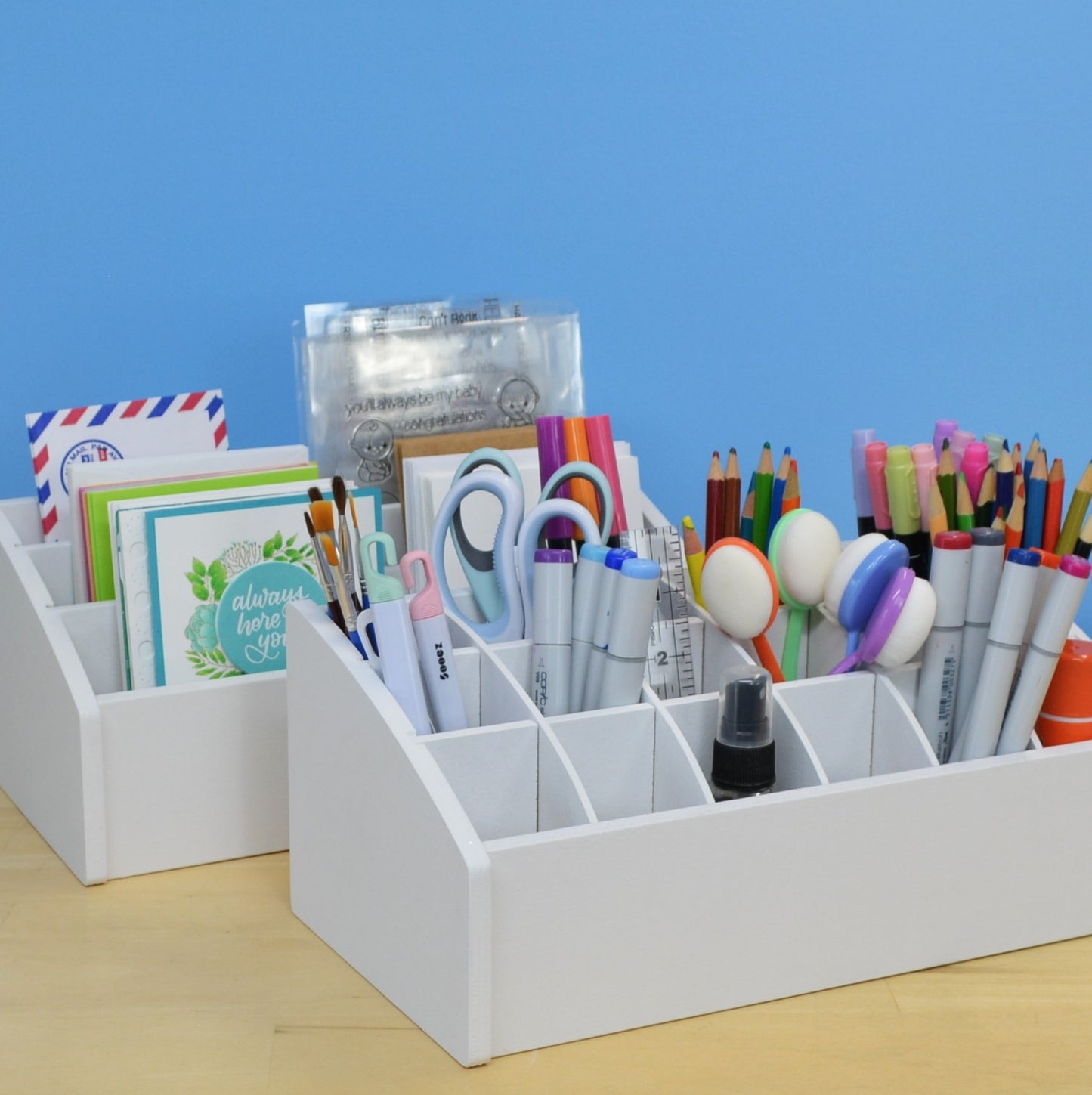 two desk caddies, one for greeting cards and the other for crafting tools. both painted white