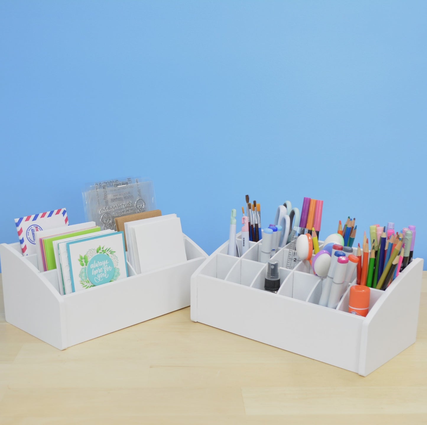 a craft organizer full of greeting cards beside an organizer holding crafting tools