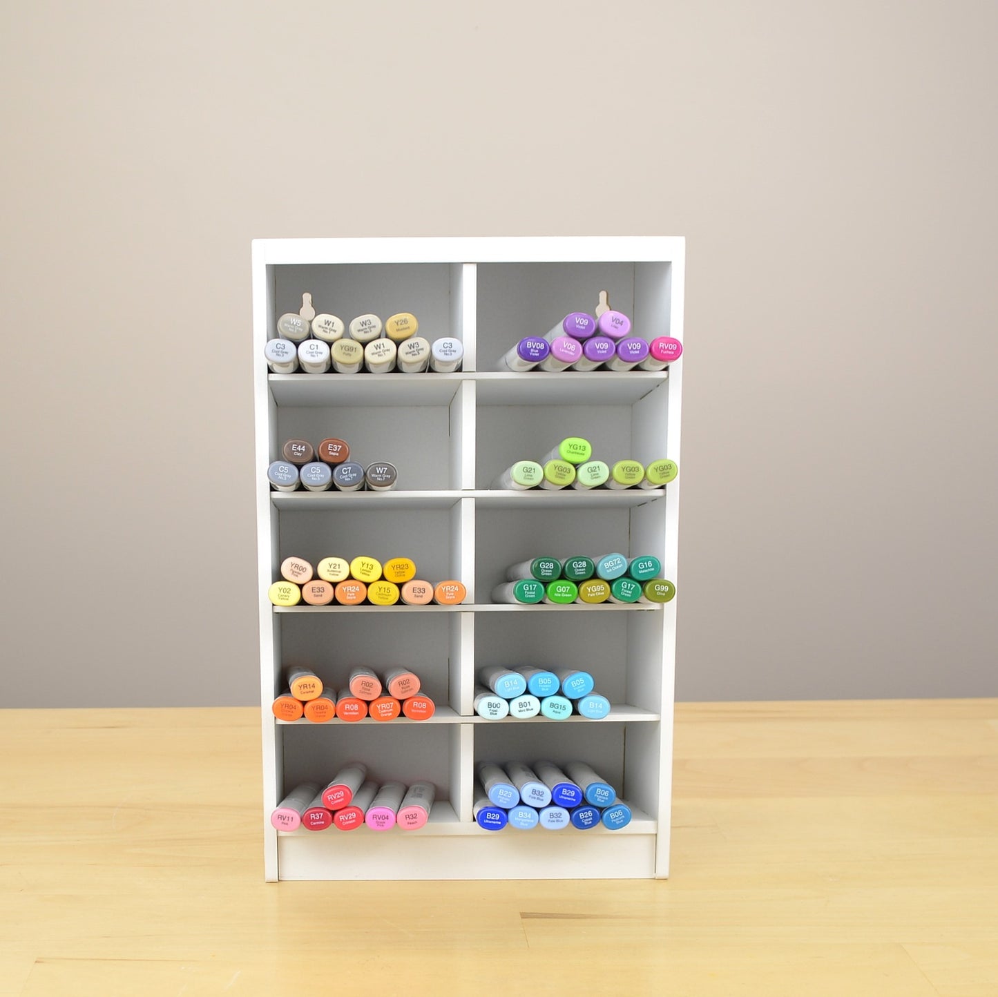 Front view of a marker organizer with 10 cubbies and painted white.