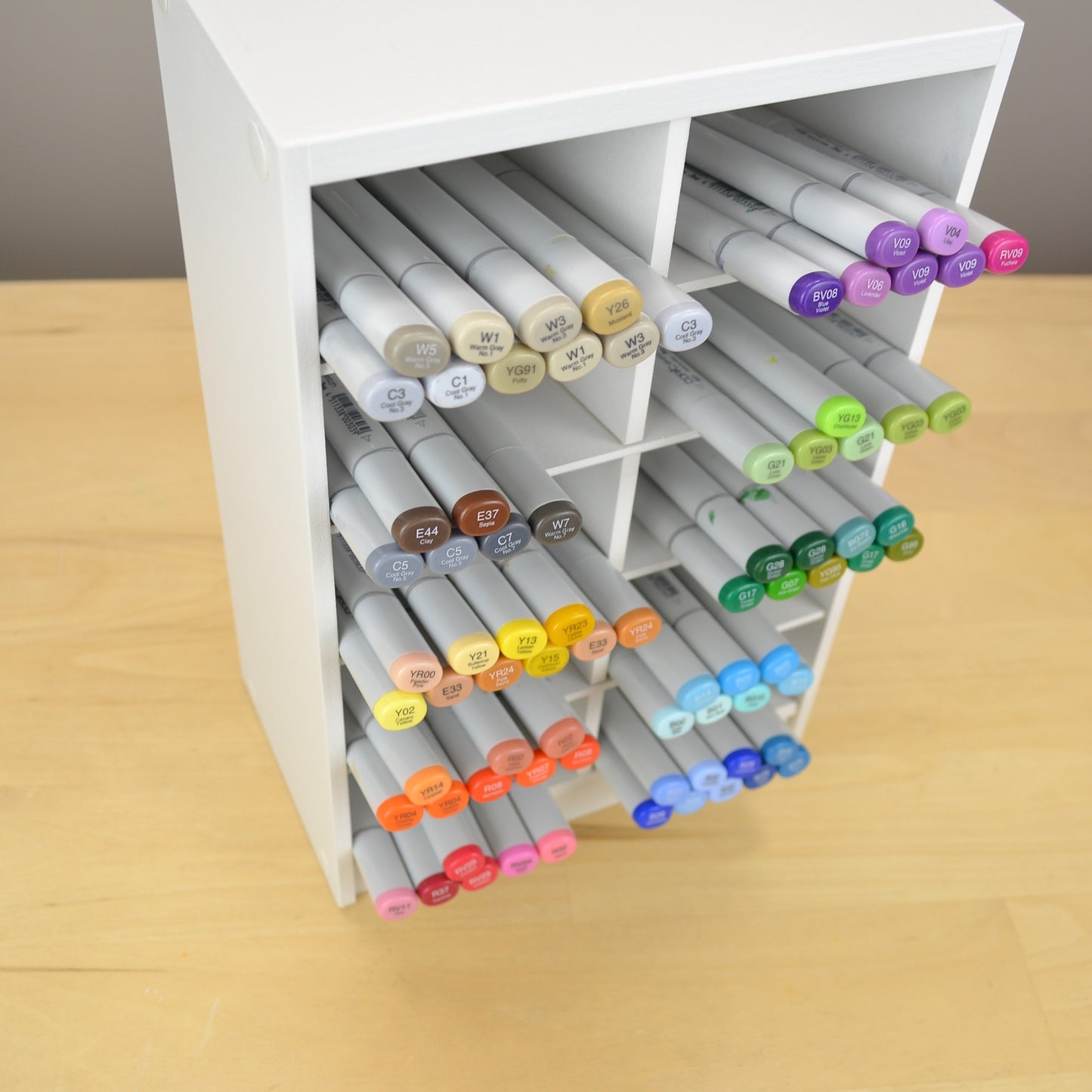 View showing Copic markers sticking out of a white craft organizer.