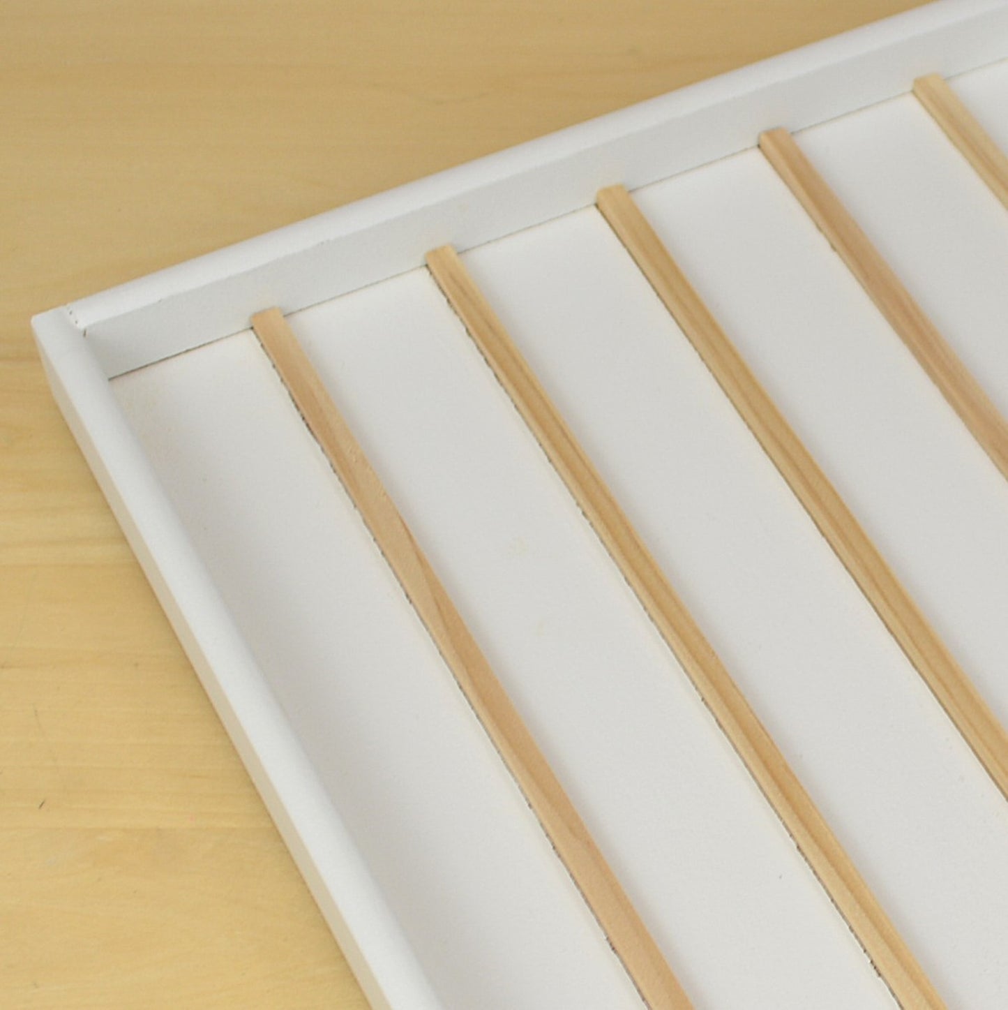 Detailed view of the wooden dividers in a mini ink cube storage tray.