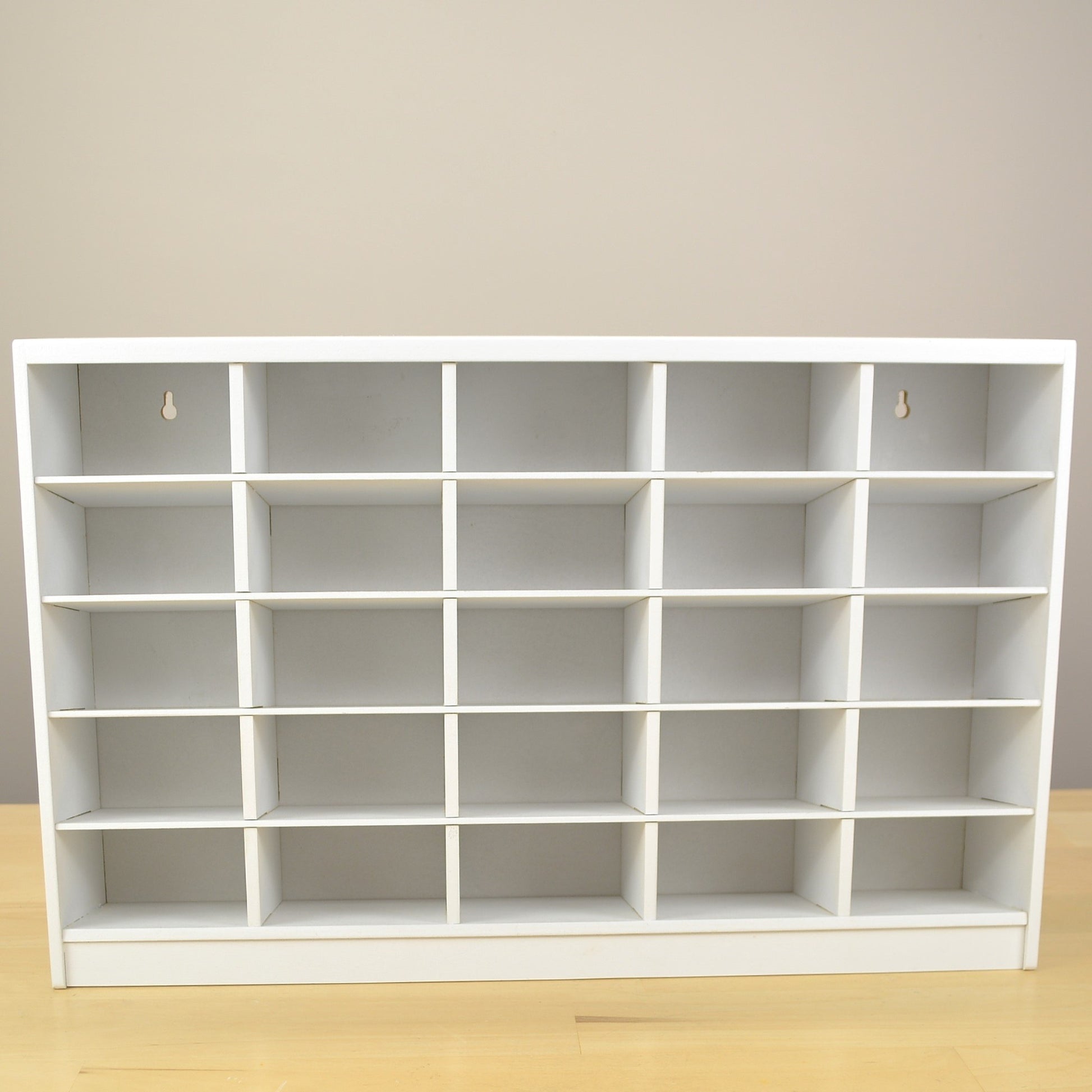 Front view showing the 25 cubbies of a white marker storage organizer.