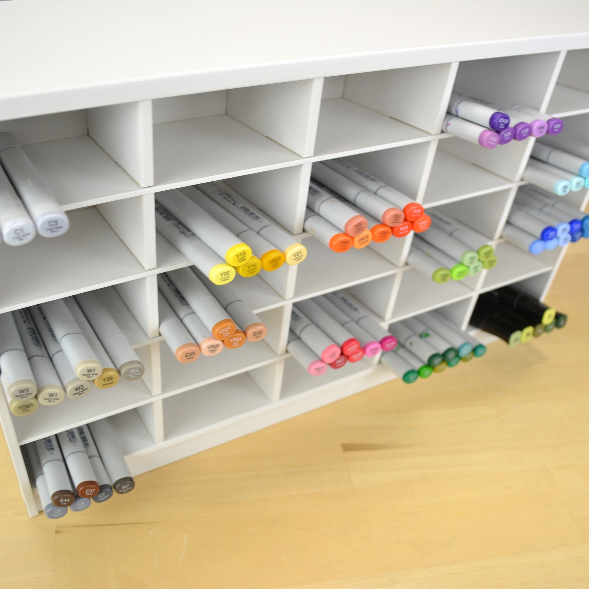 Angle view showing how far the Copic markers stick out of a white organizer.