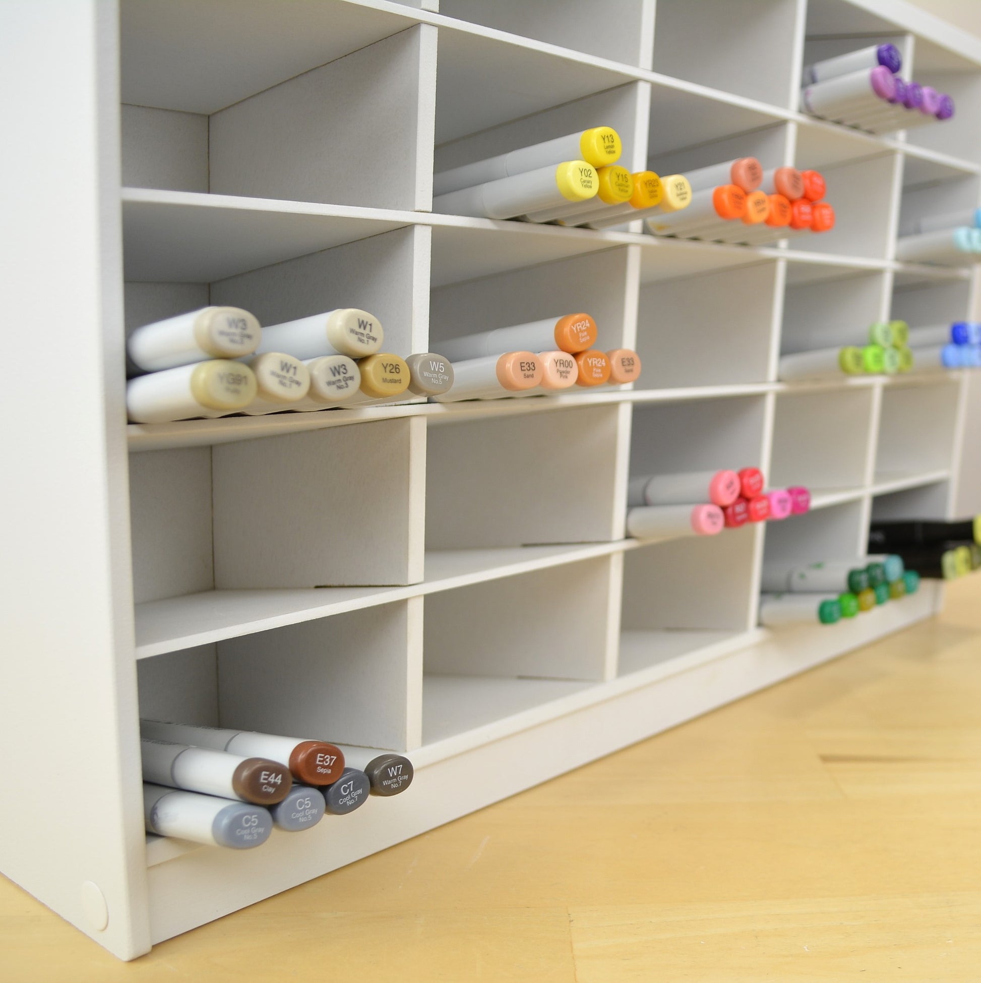 Closeup of Copic markers in a huge white craft organizer.