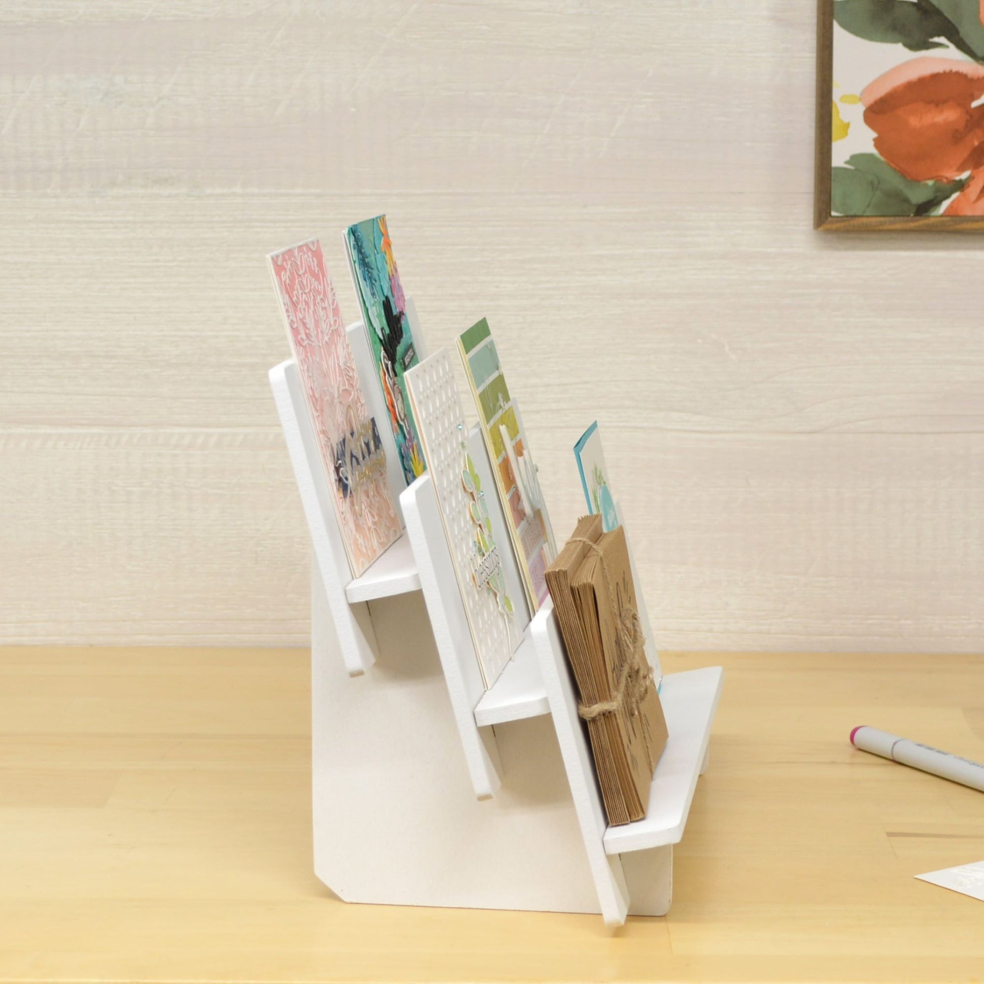 side view of a tiered shelf holding handmade greeting cards