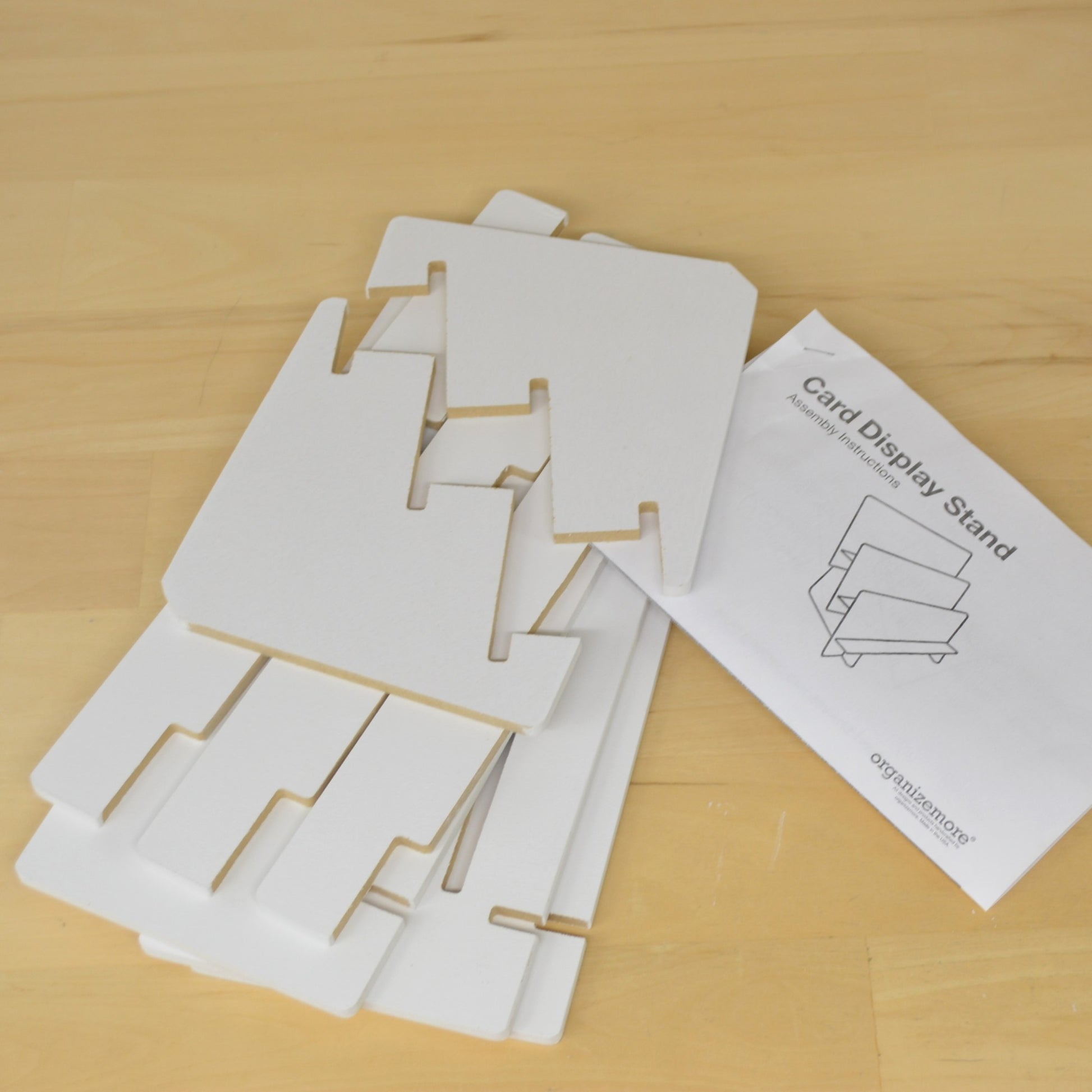 view of an unassembled tiered shelf unit made to hold greeting cards