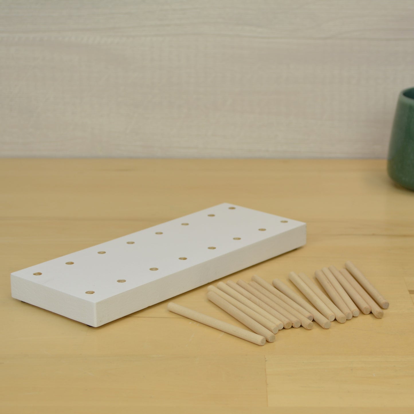 view showing the two rows of holes and wooden dowels in a desktop card
organizer
