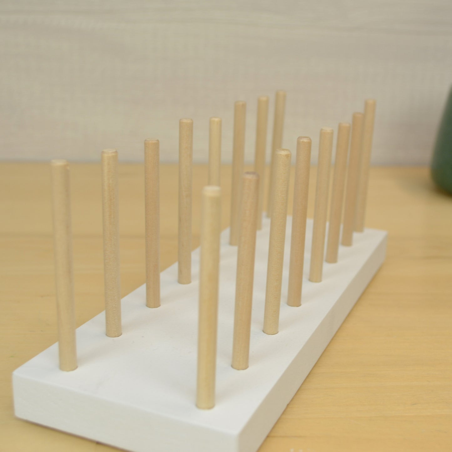 desktop organizer with two rows of wooden peg to hold greeting cards