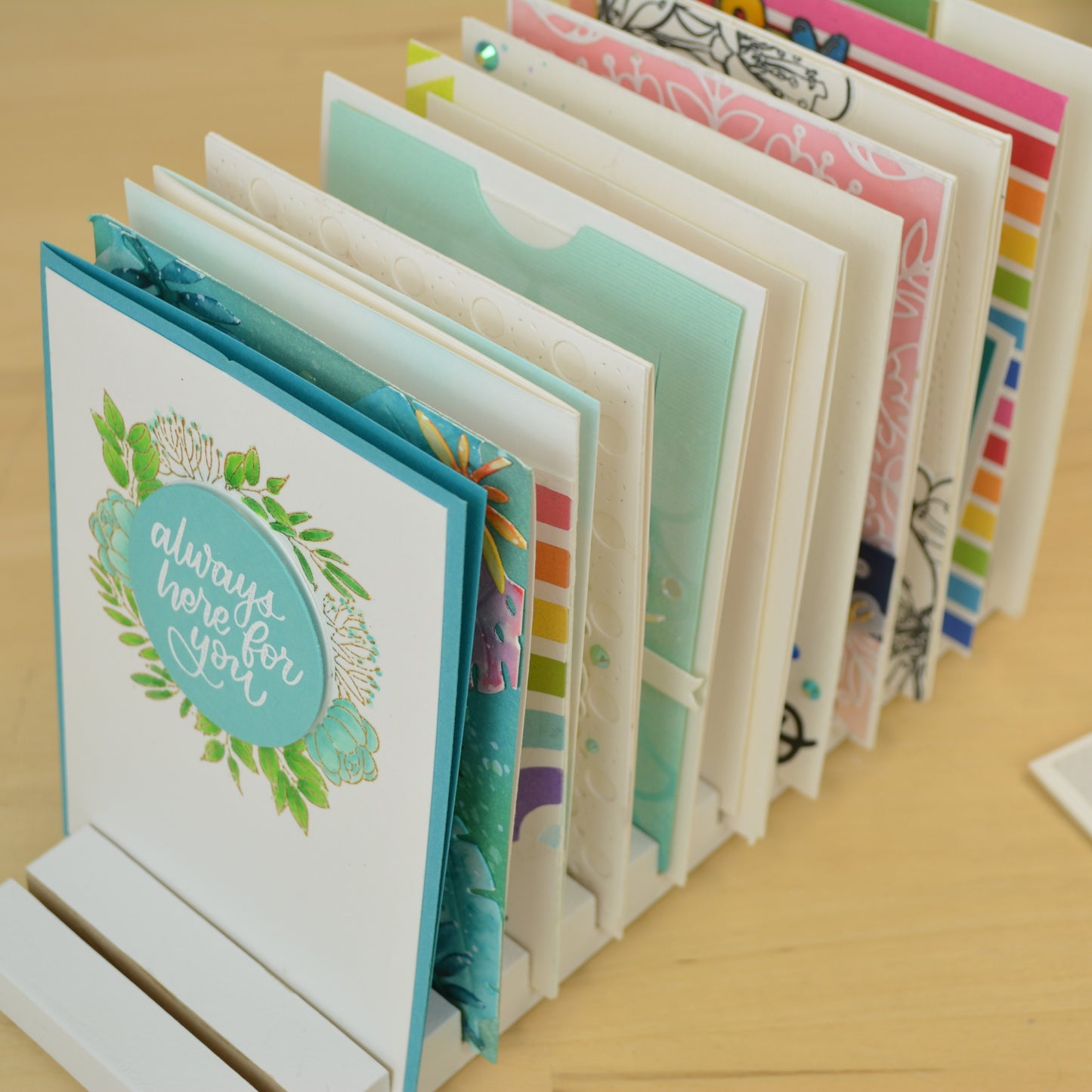 closeup view of handmade greeting cards in a white drying rack