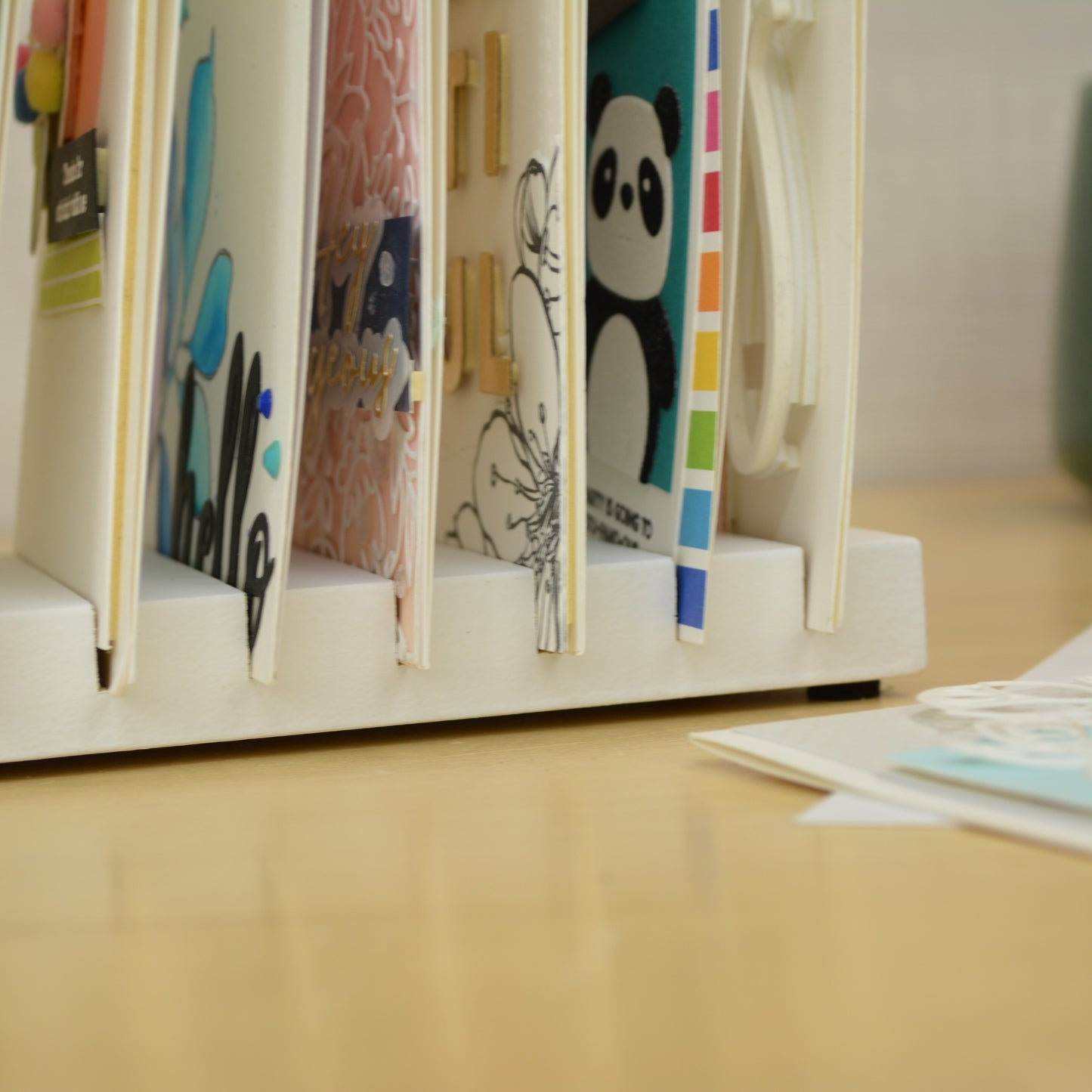closeup view of greeting cards in the slots on a card drying rack