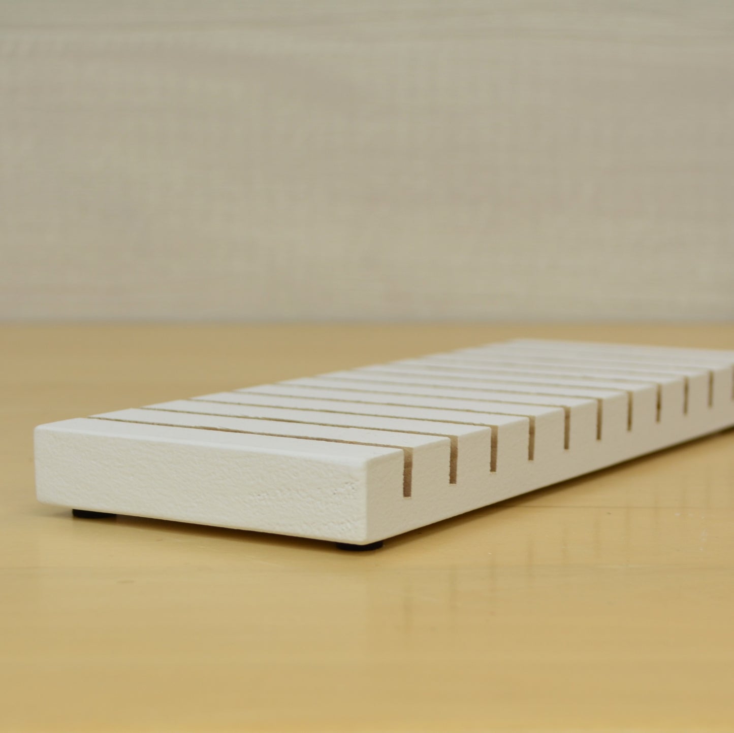 angle view of a white greeting card stand painted white