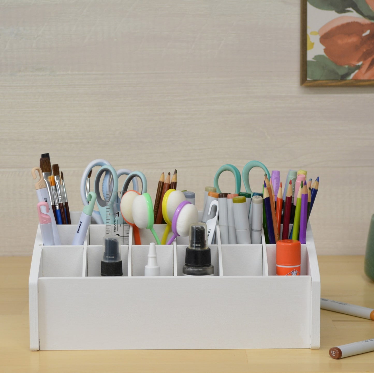 front view of a white desktop organizer full of crafting tools