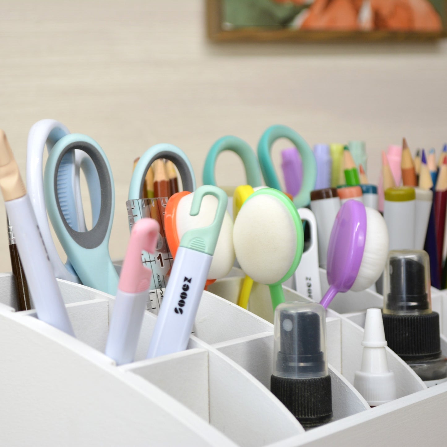 closeup view of a craft organizer full of scissors, pencils, blending tools and markers