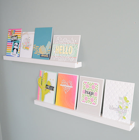floating shelves displaying handmade greeting cards