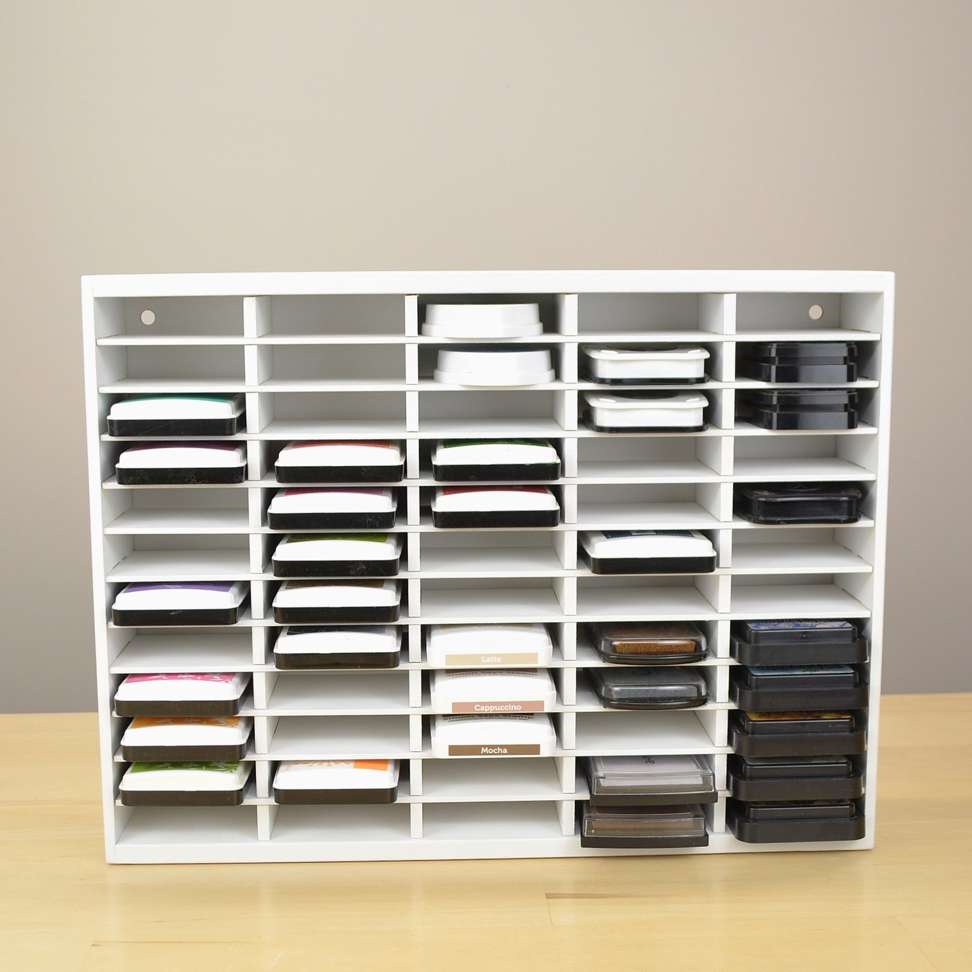 Ink pads in a white storage organizer that's designed for standard sized inks. 