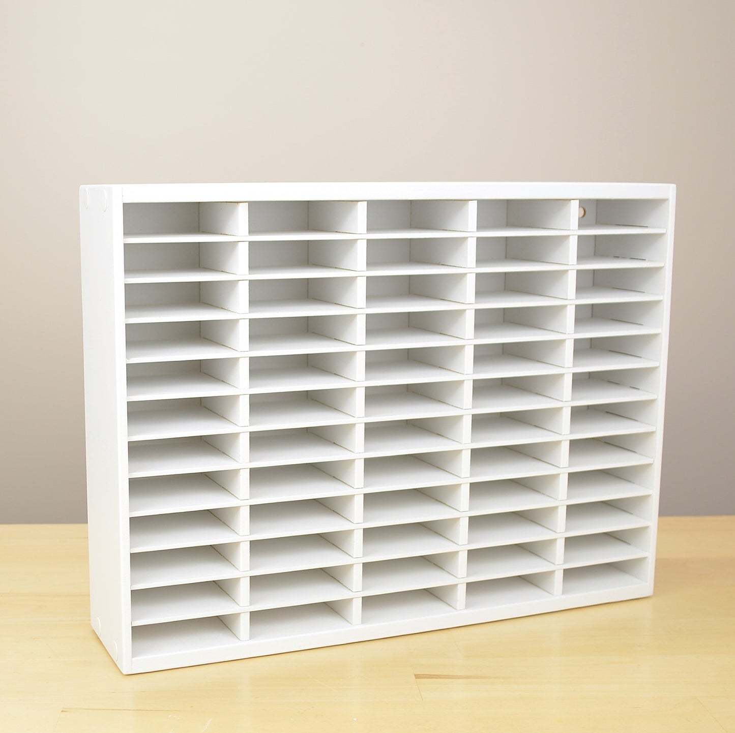 A white ink pad storage organizer that's made to hold 60 standard size pads. 