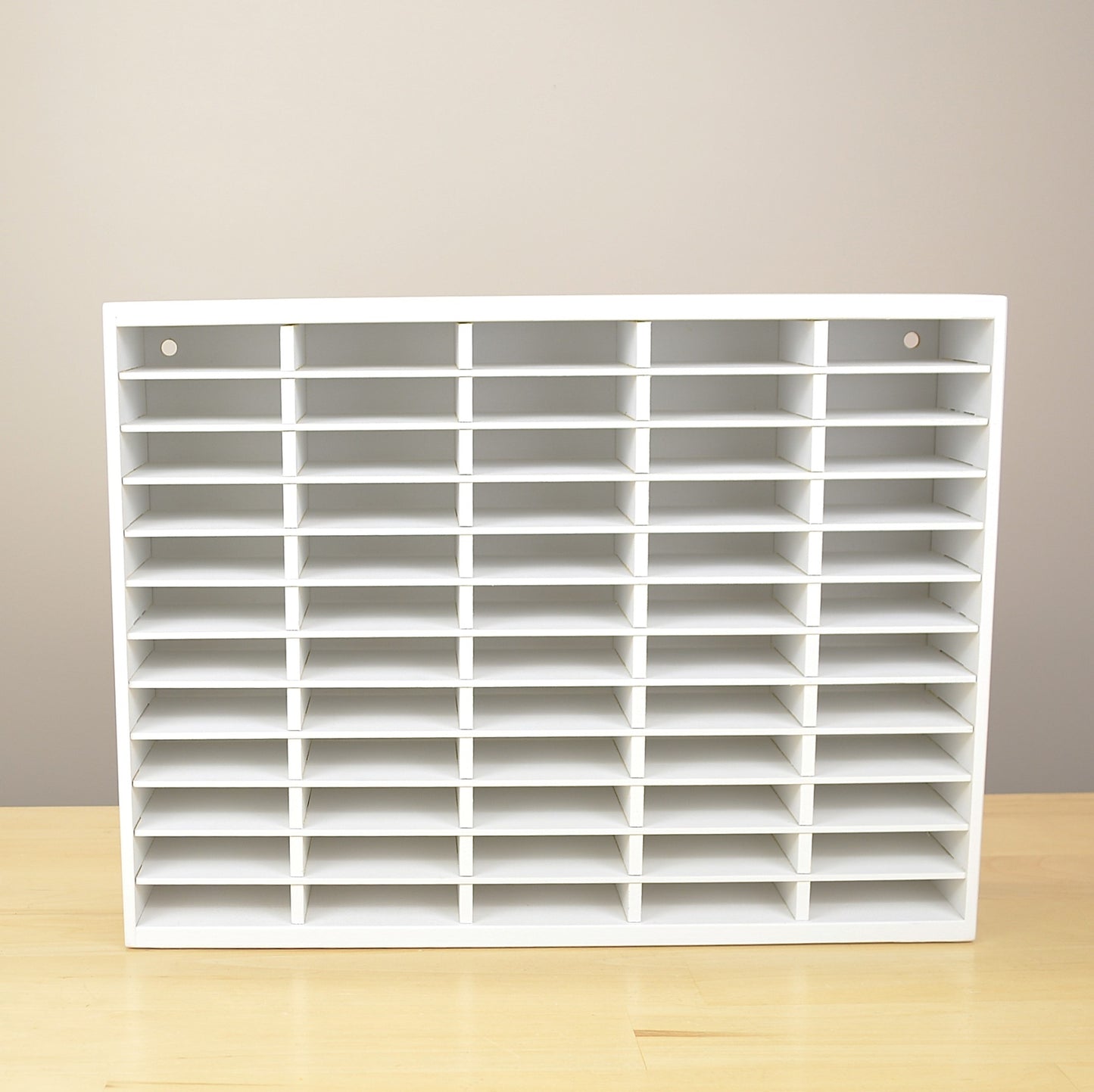 Front view of a 60 slot ink pad holder painted white. 
