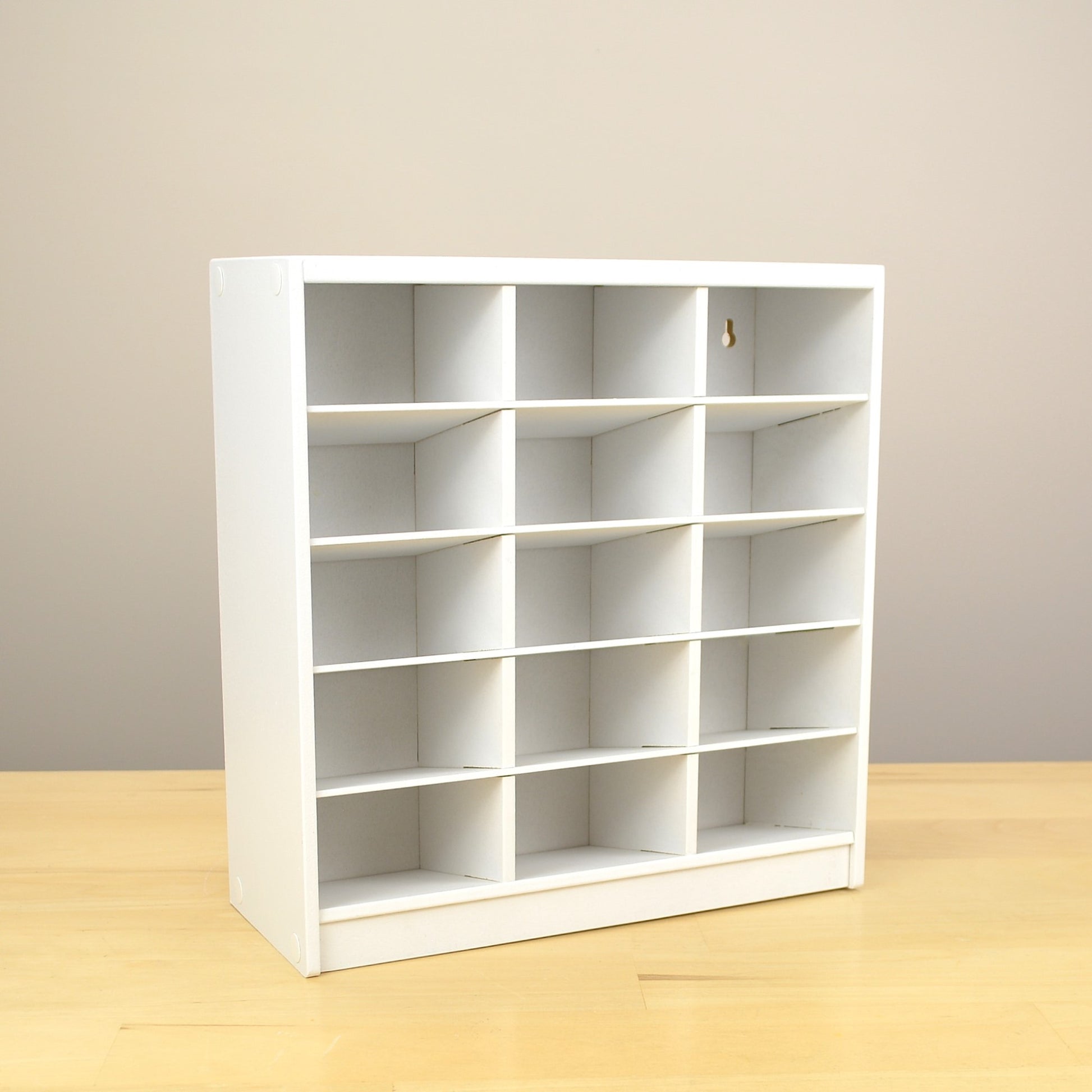 A 15 cubby marker organizer with slanted shelves to hold Copic markers. 