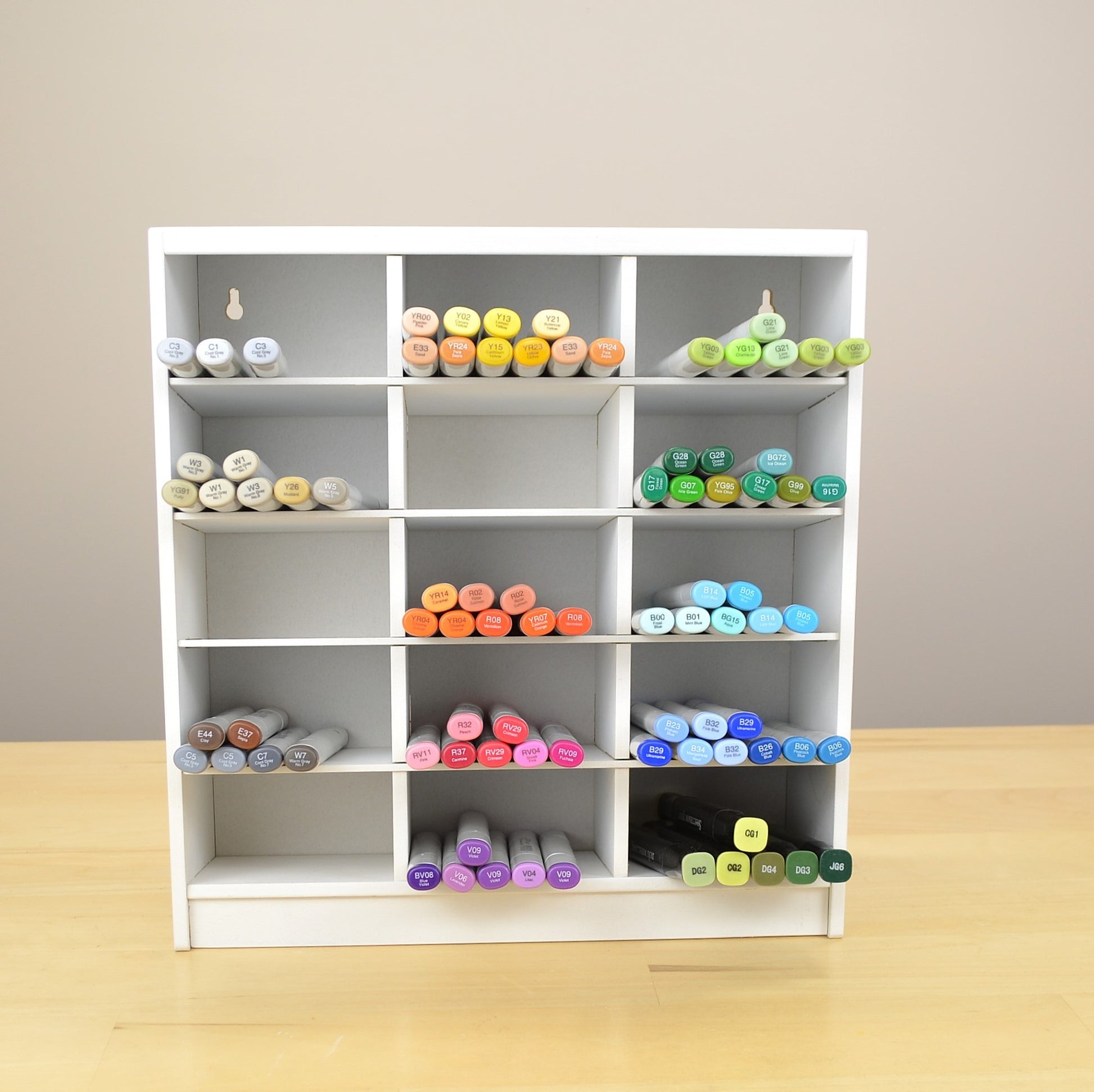 Colorful craft markers in a white organizer made to hold 360 Copics. 