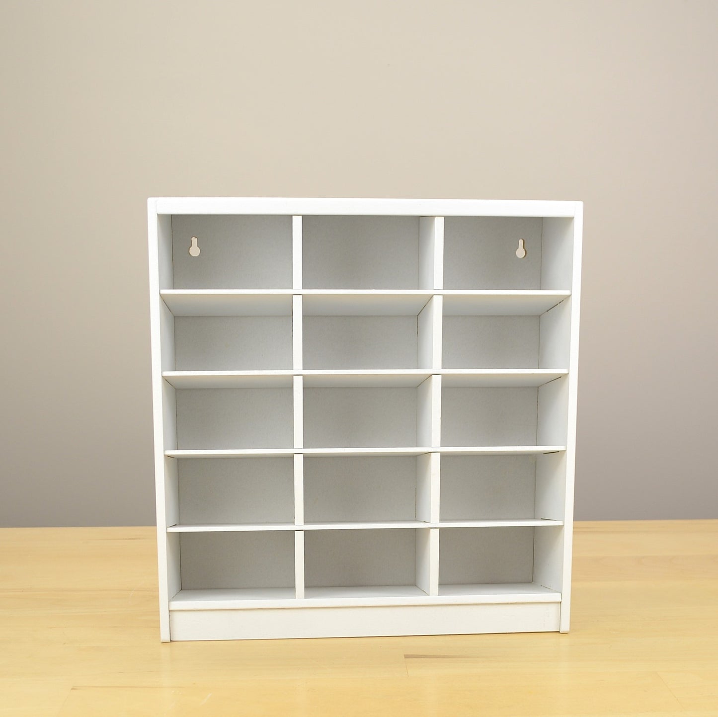 Detailed view of a white 15 cubby craft organizer. 