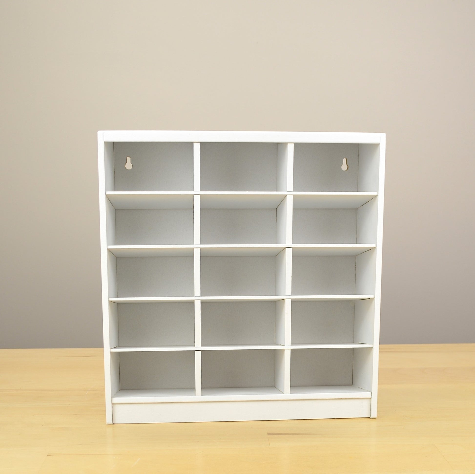 Detailed view of a white 15 cubby craft organizer. 