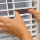 Hands displaying how the Distress Ink Spacers are placed into the ink pad organizer cubbies. 