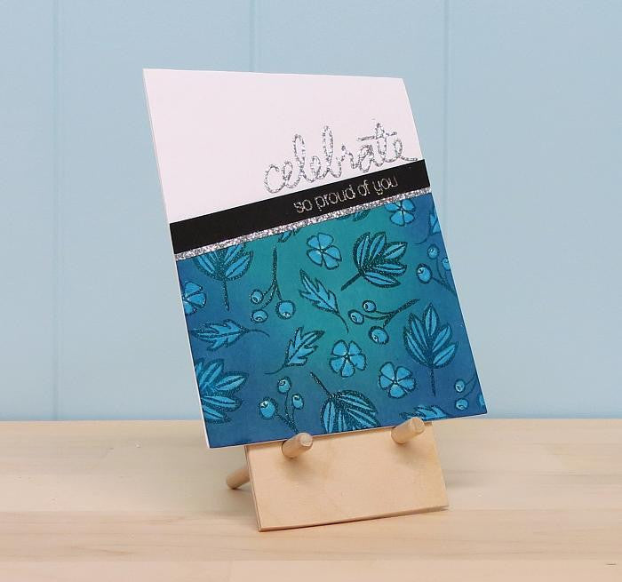 a wooden easel holding a beautiful greeting card
