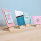 Side view of four card easels displaying cards as if at a craft show. 